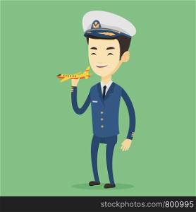 Young asian airline pilot holding model of airplane in hand. Cheerful airplane pilot in uniform. Smiling airplane pilot standing with model of airplane. Vector flat design illustration. Square layout.. Cheerful airplane pilot with model of airplane.