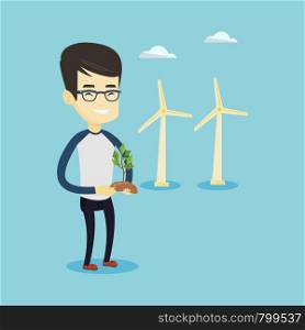 Young asian smiling worker of wind farm. Man holding in hands green small plant in soil on the background of wind turbines. Concept of green energy. Vector flat design illustration. Square layout.. Man holding small plant vector illustration.