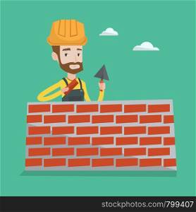 Young bricklayer in uniform and hard hat. A hipster bicklayer with the beard working with a spatula and a brick in hands on construction site. Vector flat design illustration. Square layout.. Bricklayer working with spatula and brick.