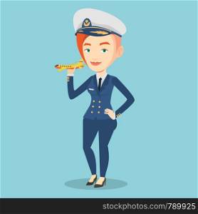 Young caucasian female pilot holding a model of airplane in hand. Cheerful female airline pilot in uniform. Smiling female pilot with model of airplane. Vector flat design illustration. Square layout.. Cheerful airline pilot with model airplane.