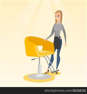 Young caucasian hairdresser standing near armchair. Full length of professional hairdresser standing at workplace. Friendly hairdresser at work. Vector flat design illustration. Square layout.. Hairdresser at workplace in barber shop.
