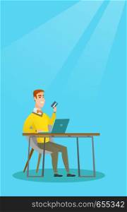 Young caucasian man sitting at the table with laptop and holding a credit card in hand. Man using laptop for online shopping and paying by credit card. Vector flat design illustration. Vertical layout. Young caucasian man paying online by credit card.