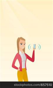 Young caucasian smiling woman holding ringing mobile phone. Happy woman answering a phone call. Woman showing a ringing phone in hand. Vector cartoon illustration. Vertical layout.. Young caucasian woman holding ringing mobile phone