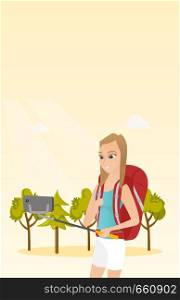 Young caucasian white traveler woman holding a selfie-stick and making selfie. Smiling traveler woman with a backpack taking photo with a mobile phone. Vector cartoon illustration. Vertical layout.. Young caucasian white traveler woman making selfie