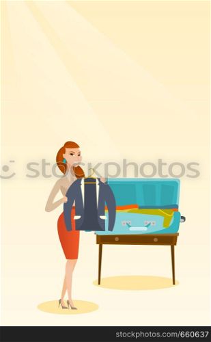 Young caucasian white woman packing her clothes in an opened suitcase. Smiling woman putting a jacket into a suitcase. Happy woman preparing for vacation. Vector cartoon illustration. Vertical layout.. Caucasian woman packing clothes in a suitcase.