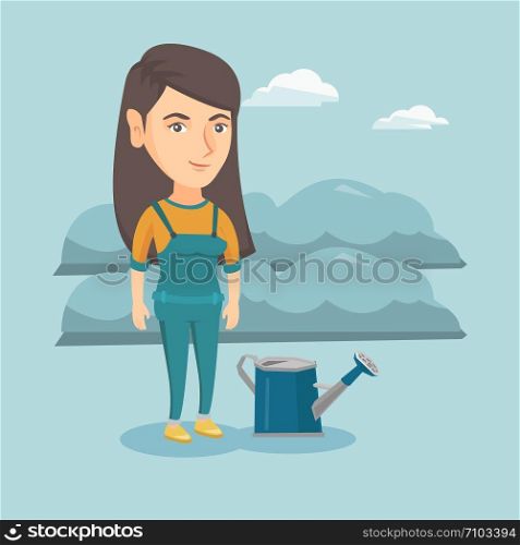 Young cheerful caucasian farmer standing near watering can on the background of agricultural field with bushes. Smiling farmer watering plants in the garden. Vector cartoon illustration. Square layout. Young farmer standing in a field with watering can