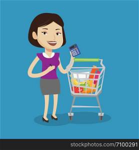 Young cheerful woman standing near supermarket trolley full with products and holding a calculator in hand. Woman checking prices with calculator. Vector flat design illustration. Square layout.. Female customer counting on calculator.
