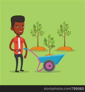 Young gardener pushing wheelbarrow with tree and dirt in the park. An african-american gardener with wheelbarrow on a background of newly planted trees. Vector flat design illustration. Square layout.. Man pushing wheelbarrow with plant.