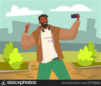 Young guy doing live streaming in street. Video blogging concept. Social media network blogger. Man is broadcasting live with his smartphone. Person uses technology for video blog and broadcast. Young guy is doing live streaming in street. Man is broadcasting with his smartphone