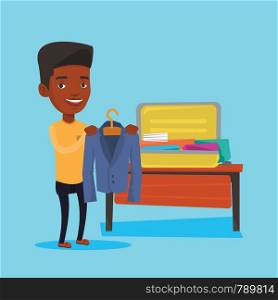 Young happy man packing his clothes in an opened suitcase. Smiling african-american man putting a jacket into a suitcase. Man preparing for vacation. Vector flat design illustration. Square layout.. Man packing his suitcase vector illustration.