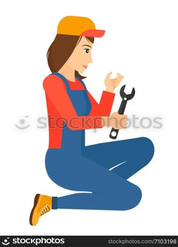 Young repairer sitting with a spanner in hand vector flat design illustration isolated on white background. Vertical layout.. Repairer holding spanner.