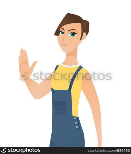 Young serious caucasian white woman in overalls showing a stop hand gesture. Concept of feminism, feminist movement, protest, woman rights. Vector cartoon illustration isolated on white background.. Caucasian white woman showing a stop hand gesture.