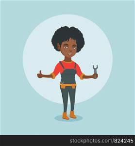Young smiling african-american female repairman standing with a spanner in hand and giving thumb up. Repairman in overalls holding a spanner. Vector cartoon illustration. Square layout.. Young african-american repairman holding a spanner