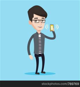 Young smiling man holding ringing mobile phone. Happy man answering a phone call. Man standing with ringing phone in hand. Vector flat design illustration isolated on blue background. Square layout.. Man holding ringing mobile phone.