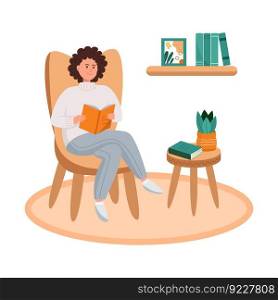 Young woman reading a book while sitting in a chair in a cozy home. 